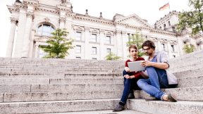 Deux étudiants avec une tablette PC sur les marches du Reichstag à Berlin.